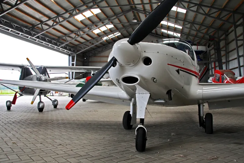A small propeller aircraft in a hangar