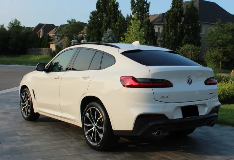 White BMW X4 on an interlock driveway