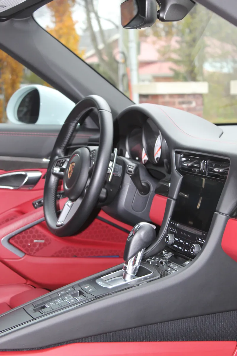 Porsche cabin with red leather and a clean dash