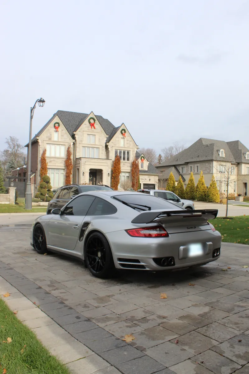 Silver Porsche 911 in a residential driveway
