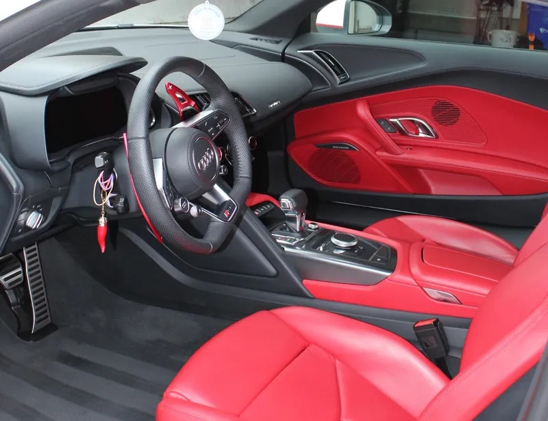 An Audi R8 cabin with red leather, spotless after a detail